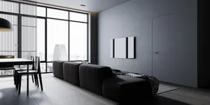 A modern living room with minimalist furniture and concrete walls.