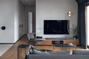 Modern living room featuring marble and metal accents, showcasing contemporary interior design principles.