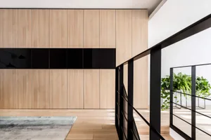 A modern living room featuring wooden paneling on the walls.