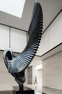 A modern metal sculpture with a sleek, flowing design.