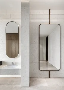 A modern minimalist bathroom featuring concrete walls and a sink