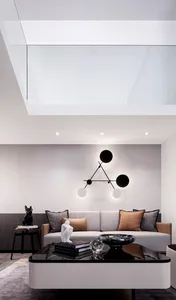Modern minimalist living room with a sleek sofa, geometric pendant light, and contemporary coffee table.