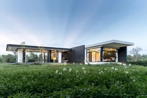 Modern home with glass walls, concrete and metal exterior