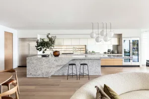 A modern residential kitchen featuring a large marble island.