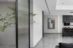 Modern living room with glass panels and minimalist design.