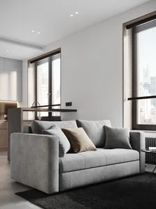 Modern living room with neutral-toned furniture, minimalist decor, and large windows.