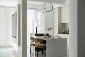 A modern residential kitchen featuring marble countertops and minimalist design.