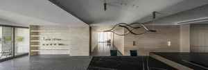 Modern minimalist living area with concrete walls and marble countertops.