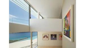A modern residential interior featuring colorful decorative paintings with visible brush strokes.