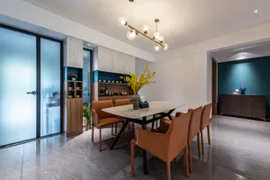Modern dining room featuring a marble table and brown leather chairs.