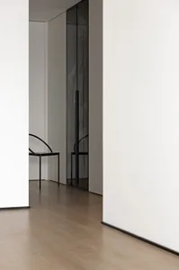 Modern minimalist room featuring a glass door and minimalist furniture.