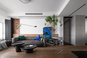 A modern living room featuring a concrete and wood interior design.