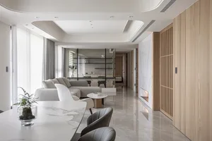 Modern living room with marble floor, sofa, and glass partition
