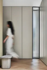 A minimalist interior design featuring metallic surfaces and translucent glass elements.