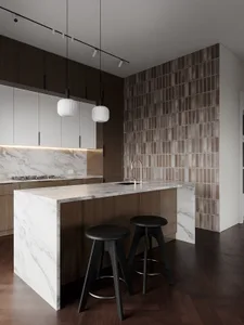 Modern kitchen with marble countertops and dark wooden cabinets.