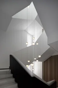 A modern minimalist staircase with glass lighting fixtures