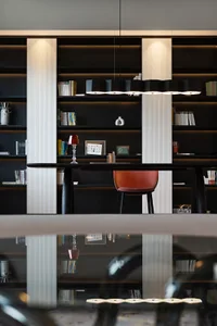 A minimalist workspace with a polished wooden desk and metallic accents.