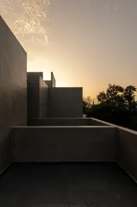Concrete architectural structures against a sunset sky