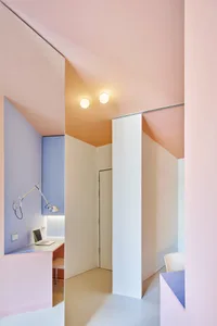 A minimalist residential room with pink painted walls and a white ceiling.