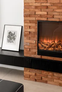 Modern living room featuring a brick wall, fireplace, and floating black shelf with framed artwork.