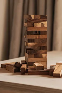 Wooden blocks stacked in a tower formation on a table.