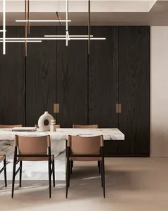 Minimalist dining room with marble table and chairs, featuring sleek design elements and natural lighting.