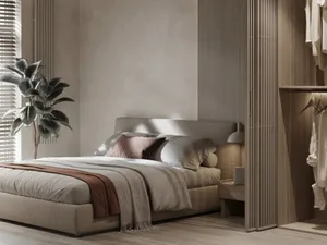 Modern bedroom featuring a comfortable bed with fabric bedding and pillows.