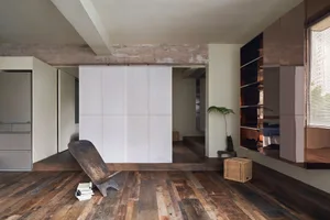 Wooden floor and furniture in an industrial-style interior design space.