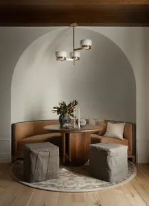 A cozy, curved seating arrangement with a wooden table in a dining room setting.