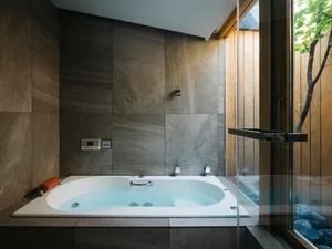 A modern bathroom with concrete tile and marble accents