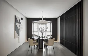 Modern dining room with a glass top dining table, wooden chairs, and a metal pendant light.
