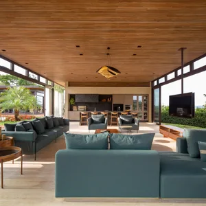 Modern living room interior with wood elements and greenery.