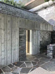 A modern building featuring a stone and concrete exterior.