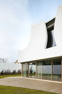 Modern exterior house with curved concrete facade