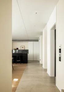 A modern interior space featuring a sleek concrete floor and a striking marble kitchen counter.