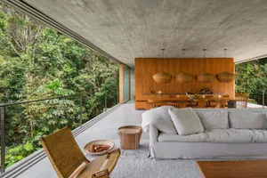 Modern interior design featuring a living room with concrete and wooden finishes.