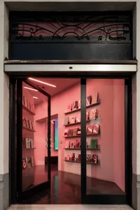 A cozy bookstore with wooden shelves, natural light, and a diverse selection of books at various heights