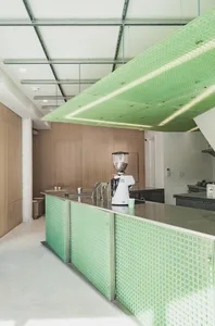A clean and organized kitchen area with a countertop, blender, cups, and bottles, emphasizing functionality and efficiency