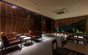 A restaurant interior with chairs and tables, creating an inviting atmosphere for socializing and dining
