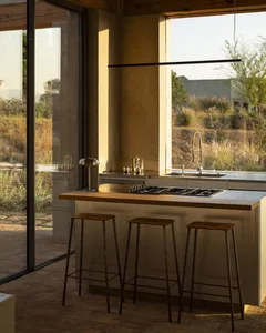 Bright and inviting modern kitchen with white cabinets, black countertops, and a kitchen island with barstools