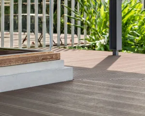 Wooden deck with two benches, well-lit by natural light, perfect for relaxation or socializing