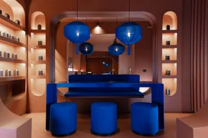 A modern restaurant interior with a blue countertop, wooden accents, and soft lighting creating a relaxing atmosphere