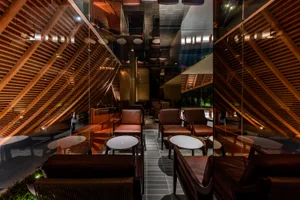 A warm and inviting cafe with brown and orange tones, featuring a mix of chairs, couches, and dining tables, perfect for relaxation and conversation