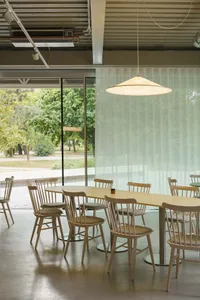 A warm and inviting dining area with a yellow table surrounded by white chairs, perfect for a cozy meal