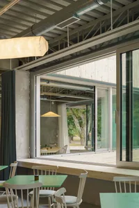 木質家具休閒餐廳空間，設有餐桌與多個杯具，營造溫暖親切的氛圍