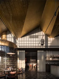 Modern bar area with gold ceiling and walls, wine glasses on countertops, and comfortable seating options