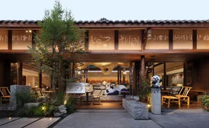 A warm and inviting Asian restaurant with wood and stone elements, comfortable seating, and lush greenery
