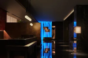 A modern bathroom with two sinks, a large mirror, and a clean, well-lit atmosphere