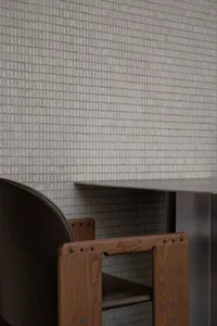 A modern dining space with a metal table surrounded by two chairs, creating a comfortable and inviting atmosphere for dining or socializing