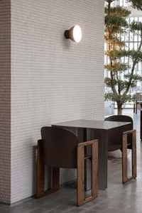 A dining area with two tables and chairs, creating a spacious seating arrangement, with an inviting atmosphere perfect for social gatherings or meals